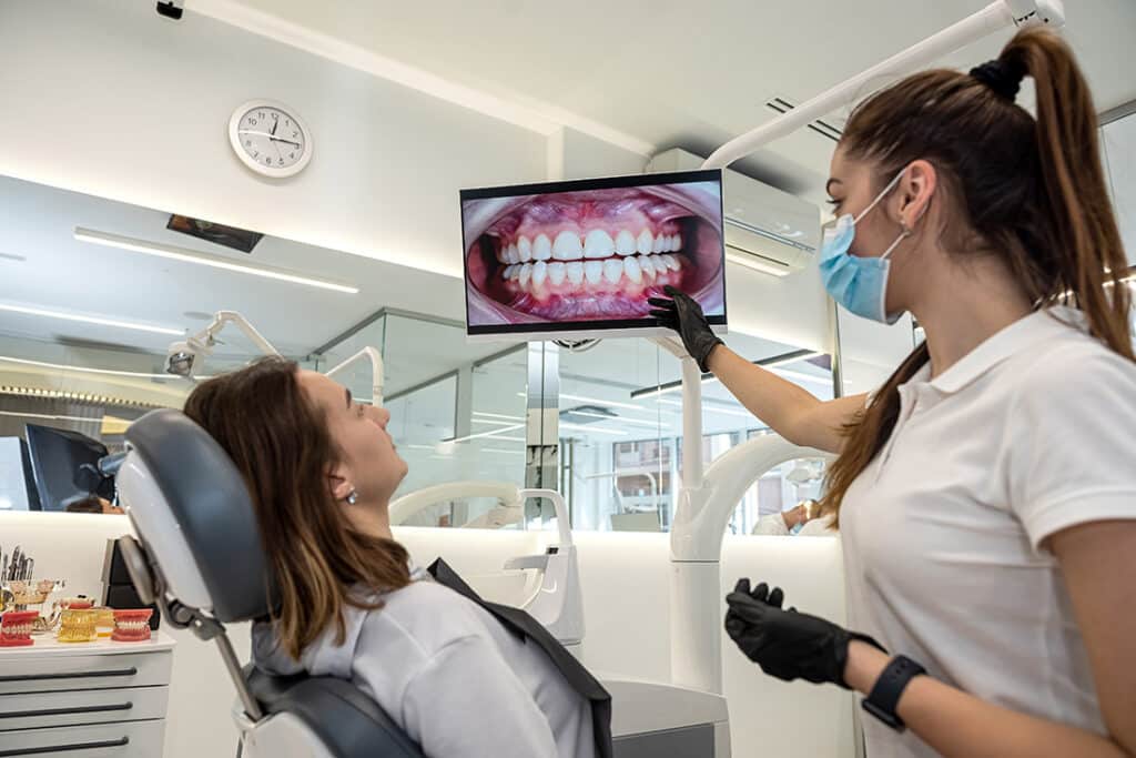 Woman being shown a closeup image of her teeth